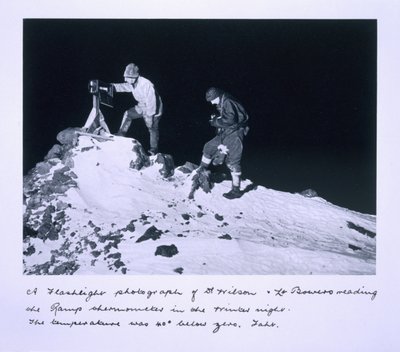 A flashlight photograph of Dr Wilson and Lt Bowers reading the Ramp thermometer. The temperature was 40 degrees below zero Fahrenheit, from 